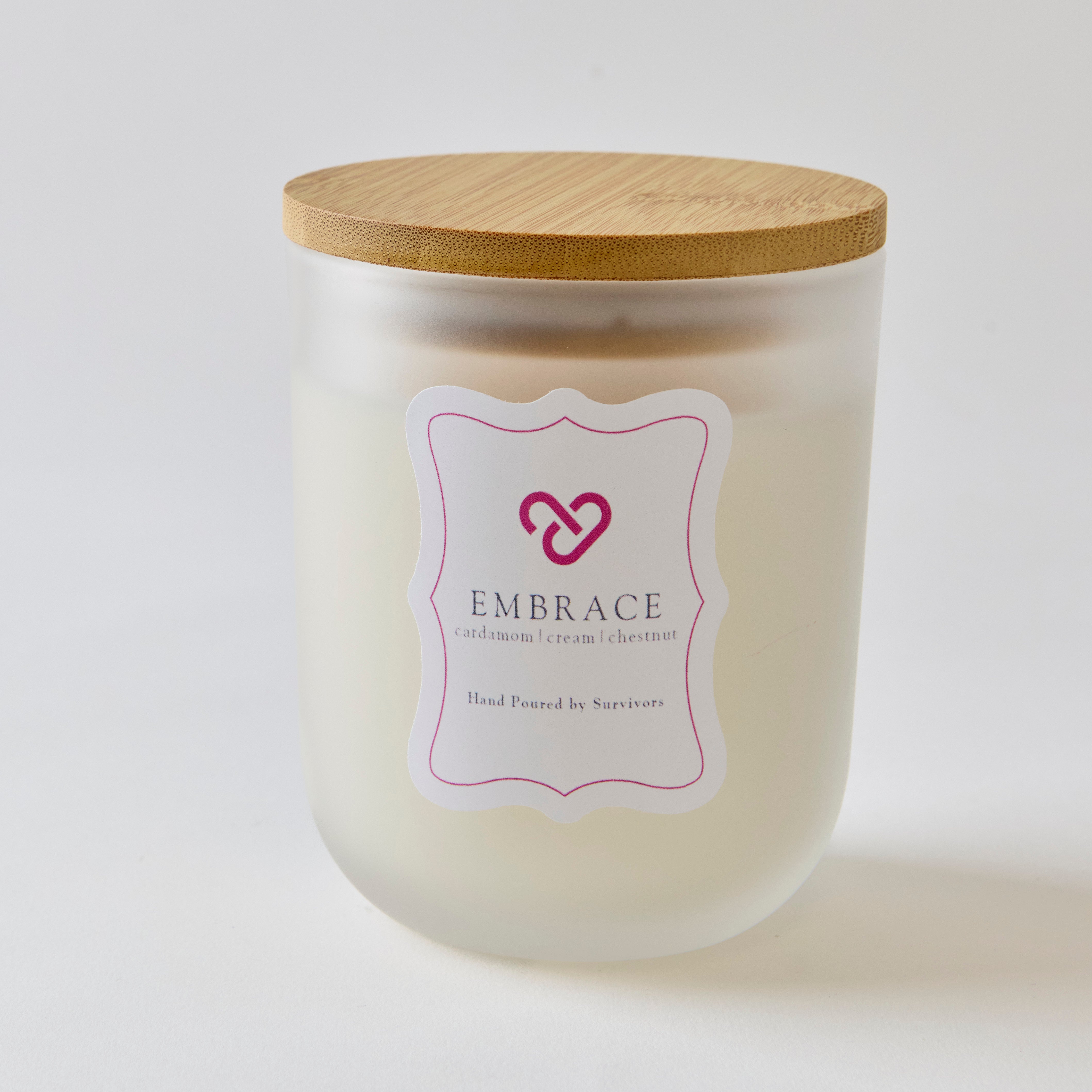 Candle in a frosted jar called EMBRACE